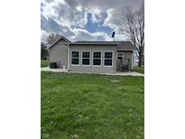Spacious backyard featuring a sunroom with large windows and a swing set at 6389 N Forest St, Martinsville, IN 46151