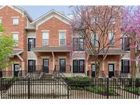 Charming brick townhomes feature wrought iron fences and blooming trees at 6585 Reserve Dr, Indianapolis, IN 46220
