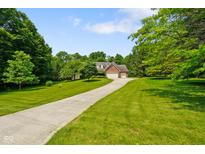 Charming brick home with a well-maintained lawn and long driveway at 6761 E Woodland Ct, Mooresville, IN 46158