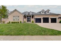 Charming brick home with a well-manicured lawn and a three-car garage, perfect for Gathering living at 6802 Carters Grove Dr, Noblesville, IN 46062