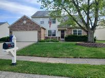 Traditional home with a brick-accented facade, a well-manicured lawn, and a mailbox with the house number at 10629 Simsbury Ct, Indianapolis, IN 46236