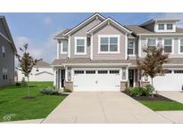 Charming townhome with a two-car garage, neatly landscaped yard, and a welcoming entrance at 1268 Newton St, Avon, IN 46123