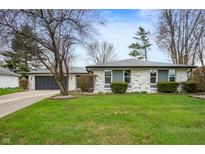 Charming ranch-style home with a stone facade, well-maintained lawn, and attached garage at 2200 W Christy Ln, Muncie, IN 47304