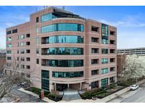 Modern building with curved architectural glass, manicured landscaping, and inviting entrance at 225 N New Jersey St # Apt 48, Indianapolis, IN 46204