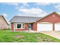 Charming brick home with an attached two-car garage and well-maintained front lawn at 229 Waterford Ct, Avon, IN 46123