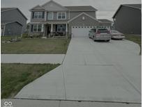 Charming two-story home featuring a brick and siding facade, well-manicured lawn and a spacious driveway at 280 Walker Dr, Whiteland, IN 46184