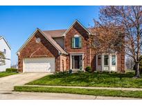 Charming two-story brick home with a well-maintained front yard and attached two-car garage at 3634 W 58Th St, Indianapolis, IN 46228