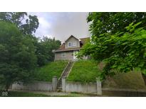 Charming home with a well-maintained lawn and inviting entrance at 3818 Graceland Ave, Indianapolis, IN 46208