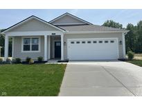 Charming single-story home featuring a manicured lawn, a two-car garage and neutral toned siding at 3915 Donaldson Creek Ct, Clayton, IN 46118