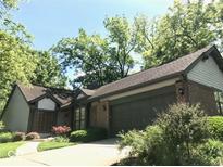 A brick and siding home with an attached garage and mature landscaping at 5329 Hawks Point Rd, Indianapolis, IN 46226