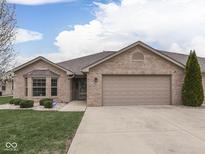Charming single-story brick home featuring an attached two-car garage and well-maintained landscaping at 5524 Coventry Park Way, Indianapolis, IN 46237