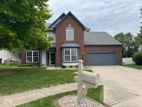 Charming two-story home with brick and siding, well-manicured lawn, and attached two-car garage at 716 Bristol Ct, Greenwood, IN 46143