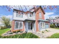 Charming two-story home with brick and vinyl siding and a well-manicured lawn in a lovely neighborhood at 716 Bristol Ct, Greenwood, IN 46143