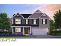 Charming craftsman-style home with a two-car garage and welcoming covered porch at 717 Lake Vista Dr, Columbus, IN 47201