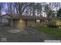 Charming home with attached garage, well-maintained lawn, and mature trees at 10129 Guilford Ave, Carmel, IN 46280