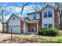 Charming two-story home with brick and siding, featuring an attached two-car garage and well-maintained landscaping at 11249 Tall Trees Dr, Fishers, IN 46038