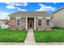 Charming single-story brick home with a well-manicured lawn and inviting front porch at 14444 Black Farm Dr, Noblesville, IN 46060