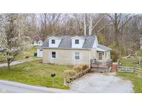 Charming one-story home featuring a cozy front porch and well-maintained yard, nestled in a serene wooded setting at 1527 N Washington St, Danville, IN 46122