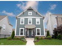 Charming two-story home with a blue-gray exterior, inviting front porch, and manicured lawn at 1534 Cloverdon Dr, Westfield, IN 46074