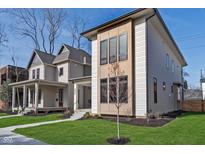 New construction with neutral siding, black trim, modern windows and professionally landscaped yard at 1822 Central Ave, Indianapolis, IN 46202