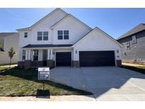 Charming two-story white home with a two-car garage, landscaped yard, and a welcoming front porch at 18944 Seaforth Way, Westfield, IN 46074