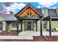 Charming home featuring a striking entryway with a custom wood-framed portico and a decorative front door at 2103 Postmaster Ln, Greenfield, IN 46140