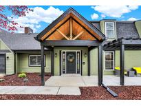 Charming home featuring a black front door with a wreath and a covered entrance with exposed wood beams at 2103 Postmaster Ln, Greenfield, IN 46140