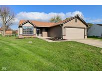 Charming single-story home with well-maintained lawn, attached garage, and inviting curb appeal at 2206 Tansel Crossing Cir, Indianapolis, IN 46234