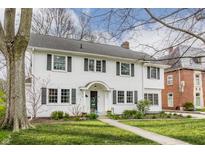 Charming two-story white home with a well-manicured lawn and traditional architectural details at 4451 N Washington Blvd, Indianapolis, IN 46205