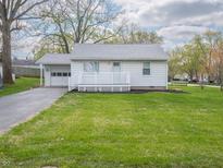 Charming home featuring a quaint porch and an attached one car garage at 4897 Walker St, Greenwood, IN 46143