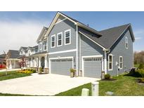 Beautiful two-story home showcasing a two-car garage, manicured lawn, and classic gray siding at 5300 Veranda Dr, Noblesville, IN 46062
