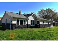 Charming single-story home with black and cream exterior and well-maintained lawn at 601 Duane St, Franklin, IN 46131