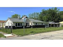 Charming single-story home featuring a well-maintained lawn, a chain-link fence, and a detached garage at 601 Duane St, Franklin, IN 46131