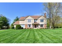 Charming two-story home featuring a well-manicured lawn and a classic facade with brick and siding accents at 611 Mill Farm Rd, Noblesville, IN 46062
