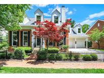 Charming brick home with a manicured front yard, black fence, and a beautiful red Japanese maple tree at 8089 Lynch Ln, Indianapolis, IN 46250