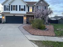 Charming two-story home featuring a well-manicured lawn, a dark garage door, and a brick and siding facade at 82 Pin Oak Ct, Whiteland, IN 46184
