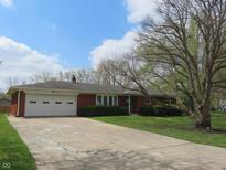 Charming brick ranch home featuring an attached garage and a well-manicured front lawn at 9113 Church Rd, Brownsburg, IN 46112