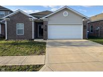 Charming single-story home with a brick facade, attached garage, and well-maintained lawn at 914 Baden Manor Dr, Indianapolis, IN 46217