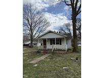 Cozy single-story home with a covered front porch and mature trees in the yard at 130 Hiawatha Dr, Noblesville, IN 46062