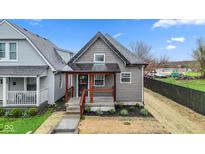 Charming home features a cozy front porch, gray siding, and freshly landscaped garden at 2118 Lexington Ave, Indianapolis, IN 46203