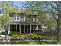 Charming two-story home with a welcoming front porch and manicured landscaping at 300 E Monroe St, Franklin, IN 46131