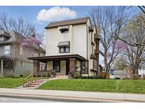 Charming two-story home with a brick-accented porch, awning-covered windows, and well-maintained lawn at 40 N Ritter Ave, Indianapolis, IN 46219
