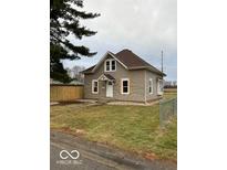 Charming two-story home featuring neutral siding, a brown roof, and a well-maintained front yard at 422 Hege Ave, Columbus, IN 47201