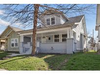Charming two-story home with a cozy front porch and well-maintained lawn at 443 N Alton Ave, Indianapolis, IN 46222