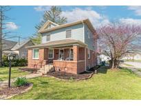 Charming two-story home with a brick facade, landscaped front yard, and inviting front porch at 504 S Lebanon St, Lebanon, IN 46052