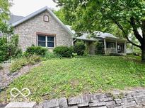 Beautiful stone exterior of a well-maintained home with mature trees and landscaping at 5846 Bellsville Pike, Columbus, IN 47201