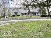 Charming stone and siding home with a welcoming front porch and well-maintained landscaping at 5846 Bellsville Pike, Columbus, IN 47201