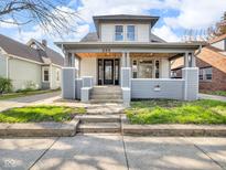 Charming two-story home with inviting front porch and well-maintained lawn at 609 E Southern Ave, Indianapolis, IN 46203