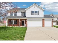 Charming two-story home with a well-manicured lawn, brick accents, and a two-car garage at 7354 Ponderosa Pines Ln, Indianapolis, IN 46239