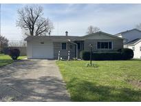 Charming single-story home with stone facade, attached garage, and well-maintained lawn at 9169 Hibben Ave, Indianapolis, IN 46229